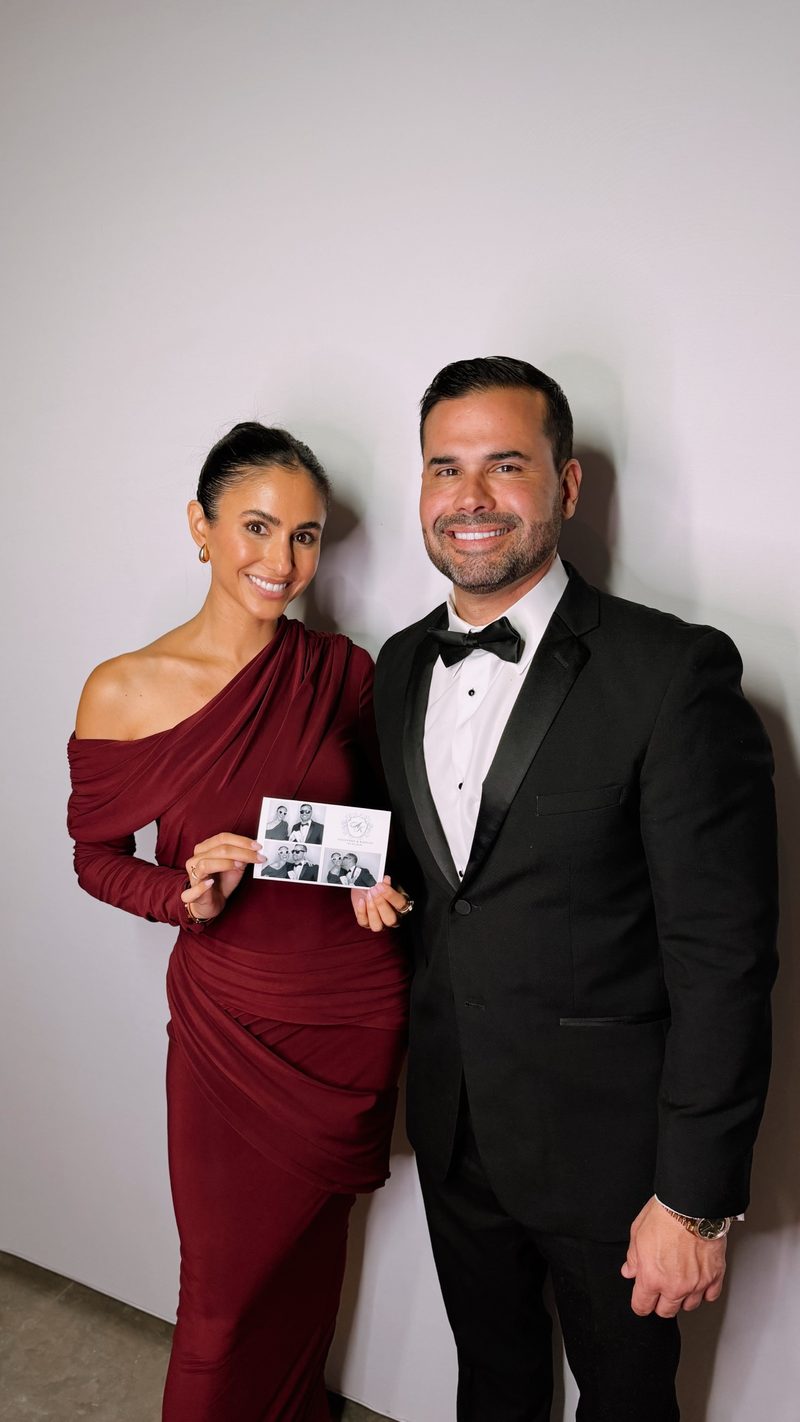 Couple in formal wear holding their wedding print
